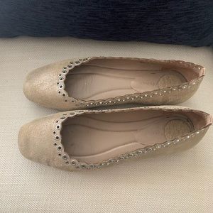 metallic beige flats with perforation and rivets